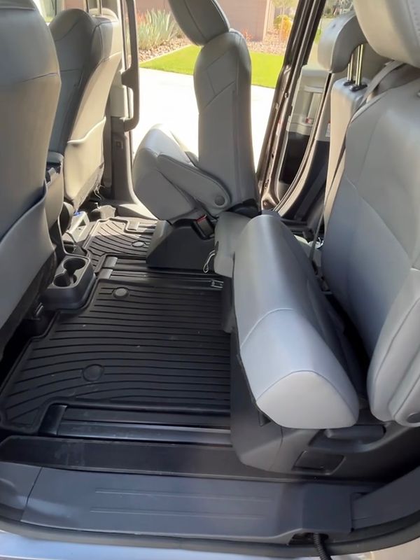 After: the same minivan's back seats and floor liners, clean, seen from the sliding door